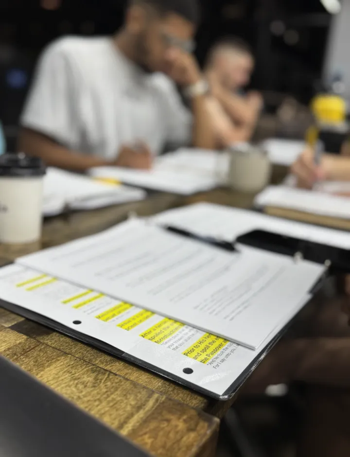 Study notes and a highlighted handout open on the table